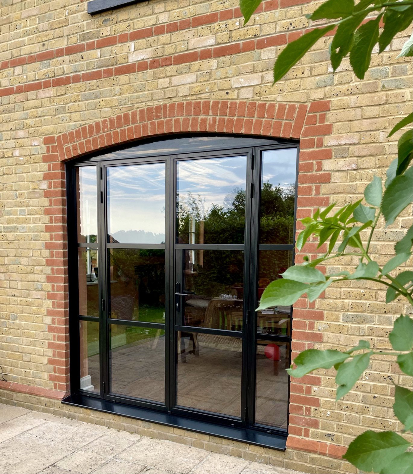 Crittall style doors in Kent house with feature arch above