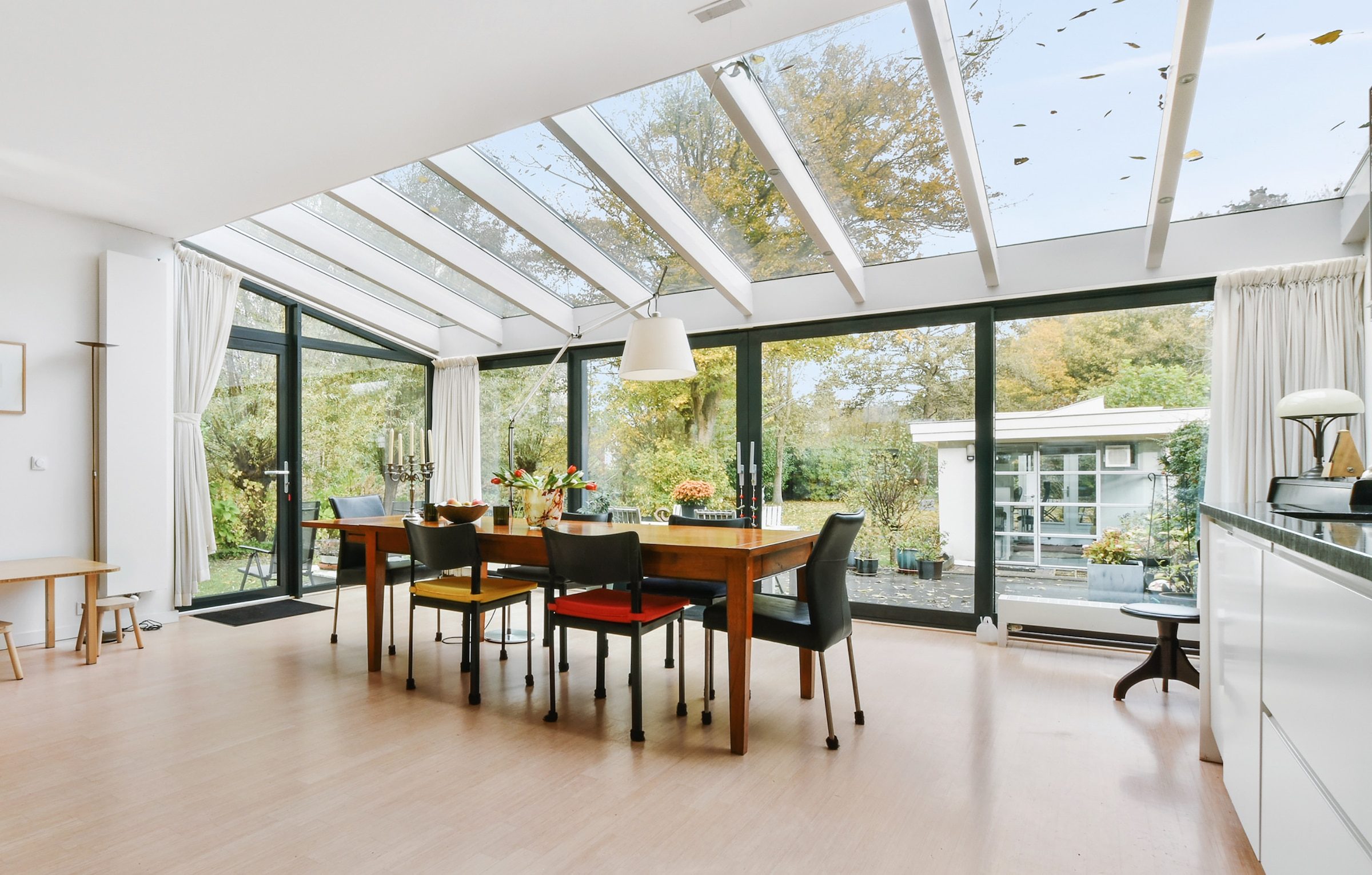 modern sliding doors in a kitchen extension with glass roof