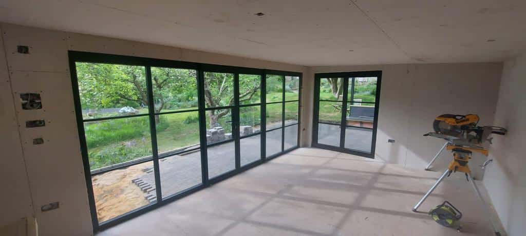 garden room with aluminium French doors in a black colour