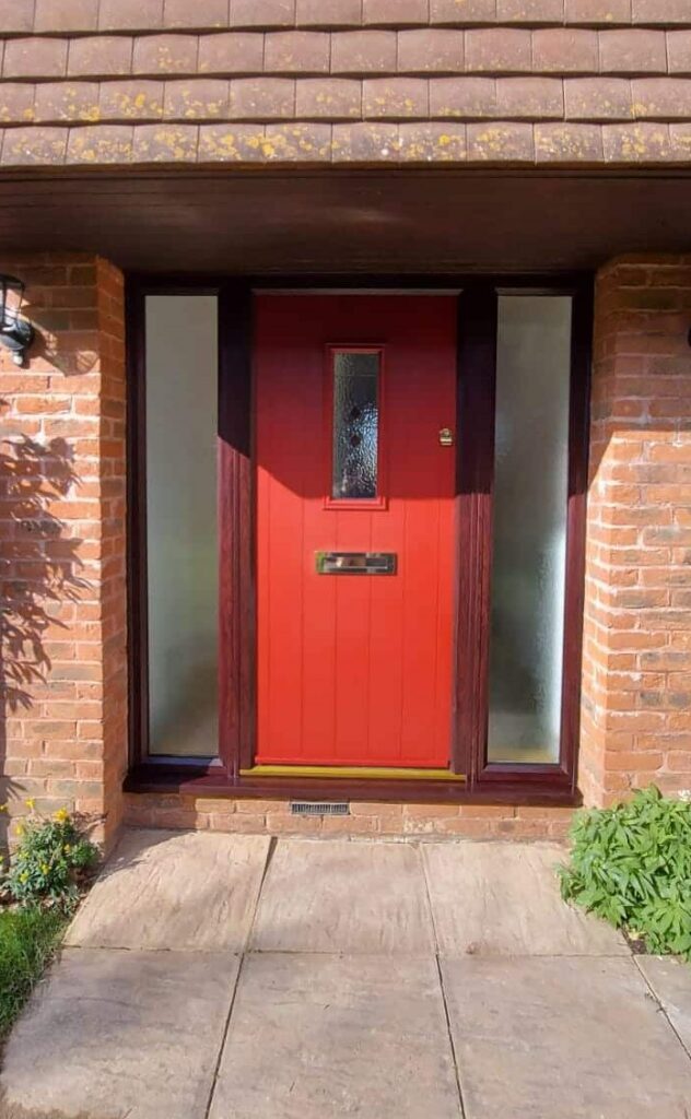 new composite front door in a red colour with wood effect frame