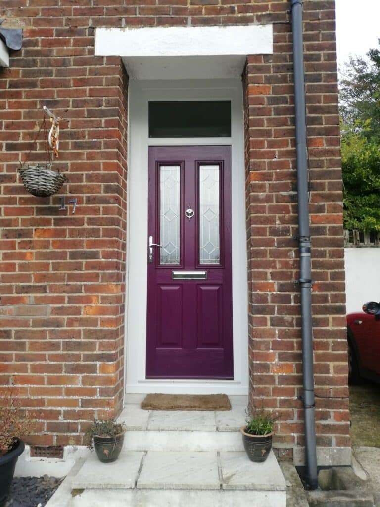 traditional composite front door in an aubergine colour.