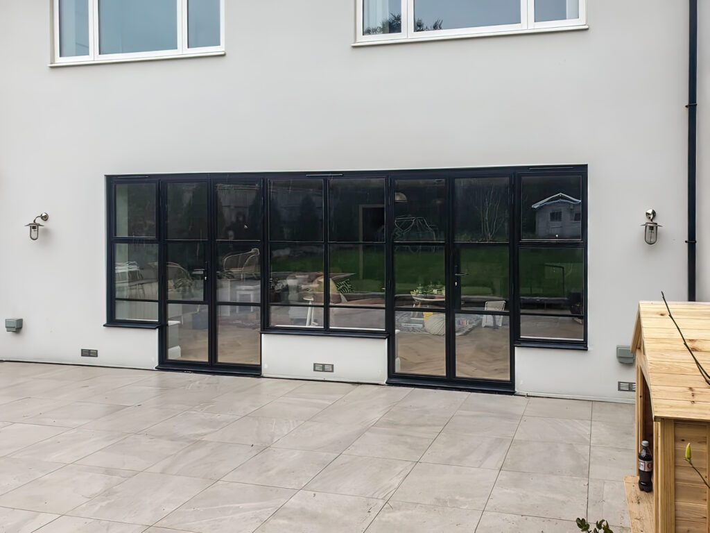 black steel look patio doors onto a blank patio area
