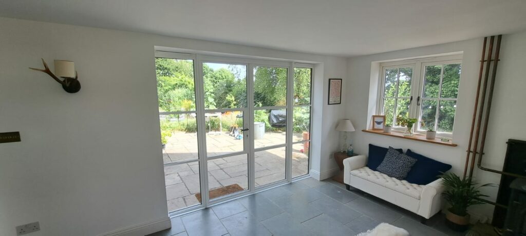 modern lounge with white steel look patio doors in Sussex