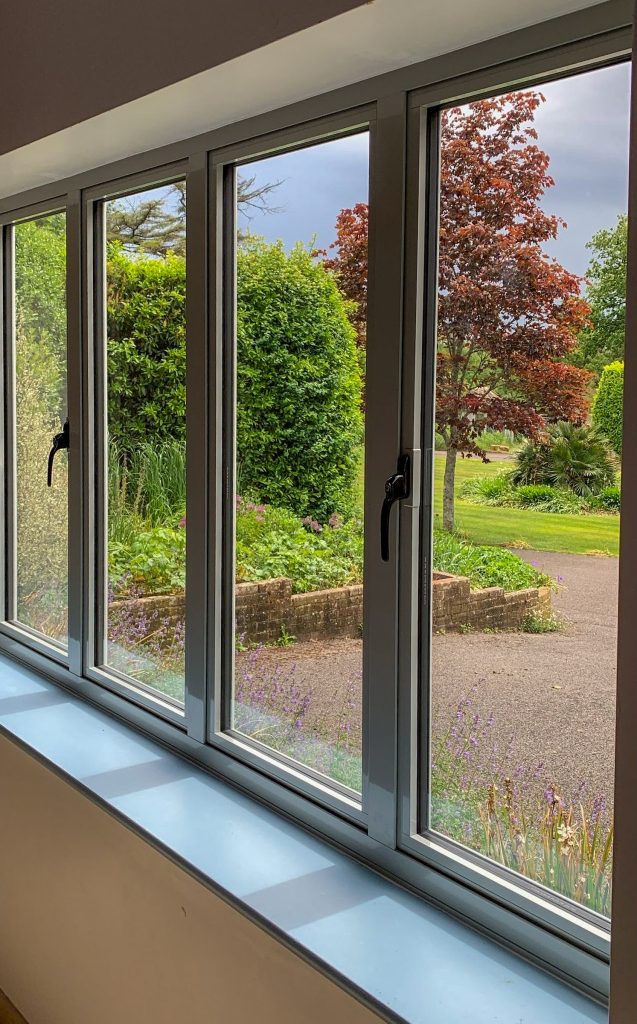 alitherm 800 windows internal view with driveway and shrubs through the glass.