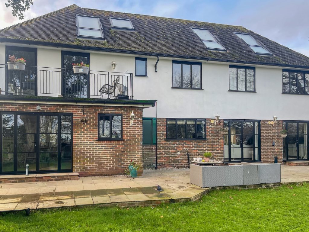 Back of detached home with modern and heritage glazing