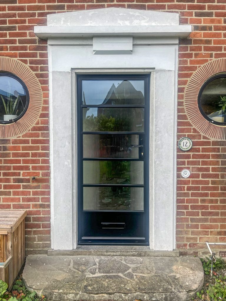 Heritage aluminium windows and doors on a detached property in Folkestone with steel look front door and aluminium porthole windows