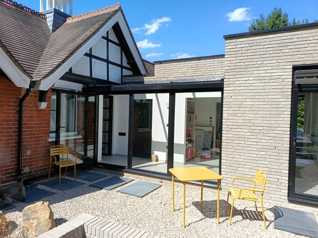 Modern brick extension with sunny gravel patio seating